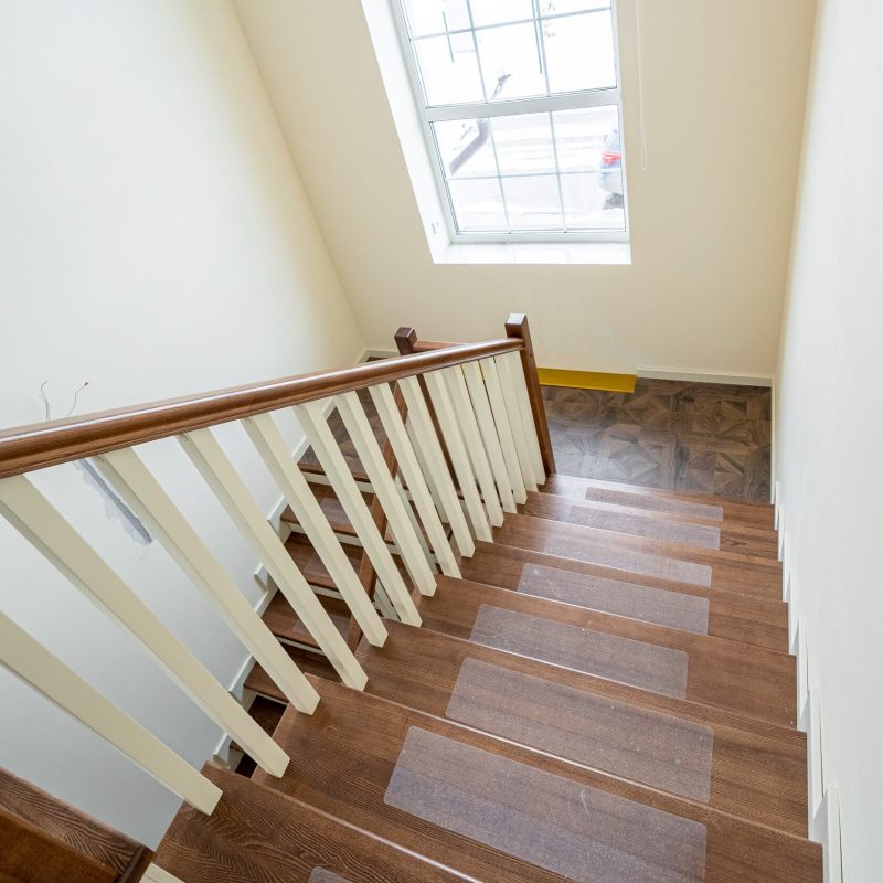 Обшивка монолитной лестницы ясенем с площадкой из паркета