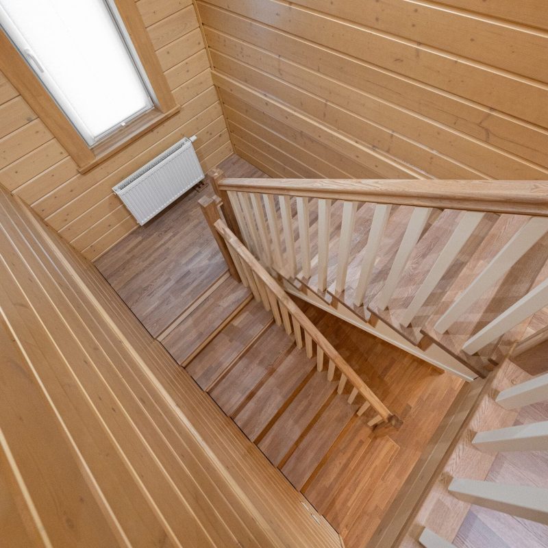 Отделка металлического каркаса лестницы ясенем с ограждением из дерева